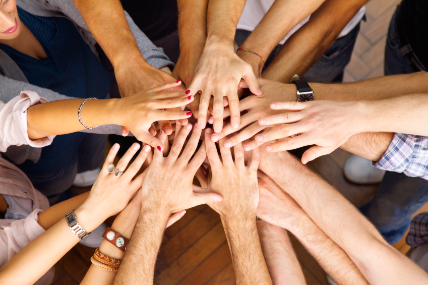 Mehrere Hände bilden ein Netzwerk in der Mitte